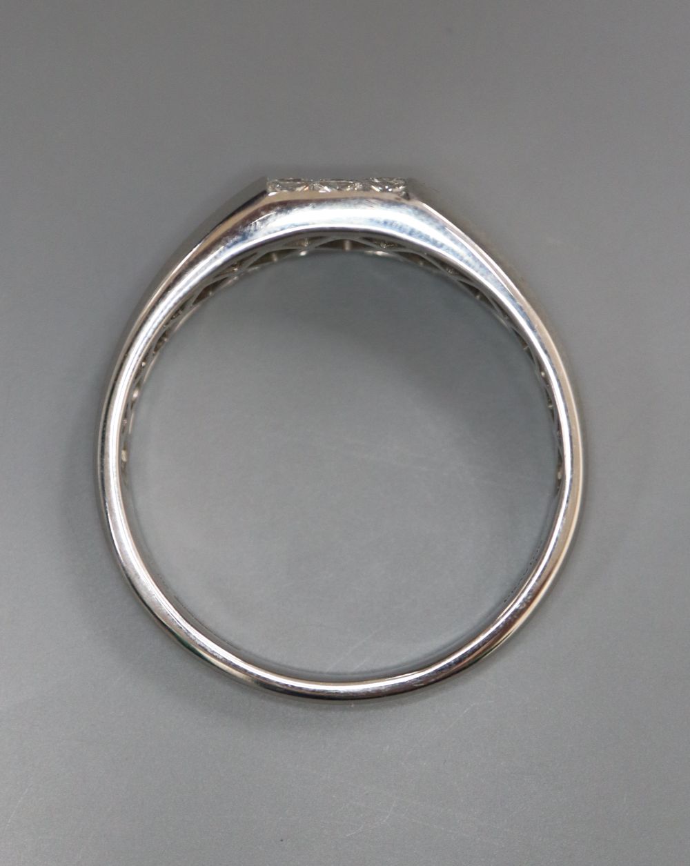A modern Pravins 18ct white gold and channel set nine stone princess cut diamond square cluster ring, size Z++++, gross 7.9 grams.